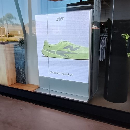 Painel de LED indoor exibindo tenis de corrida na vitrine de um outlet esportivo