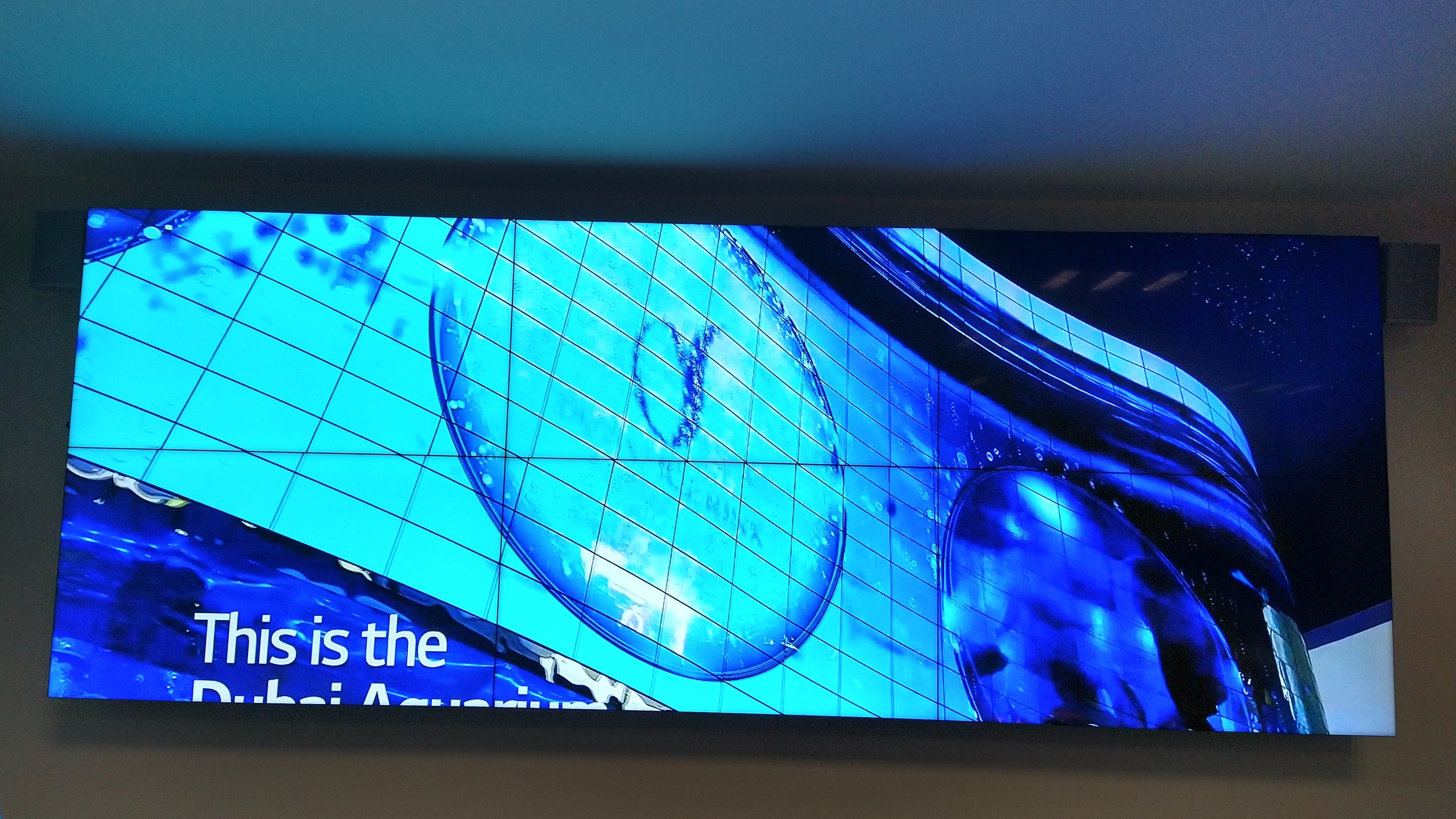 VideoWall 2x3 com as seis telas ligadas exibindo uma imagem única em tela cheia no escritório de uma instituição financeira
