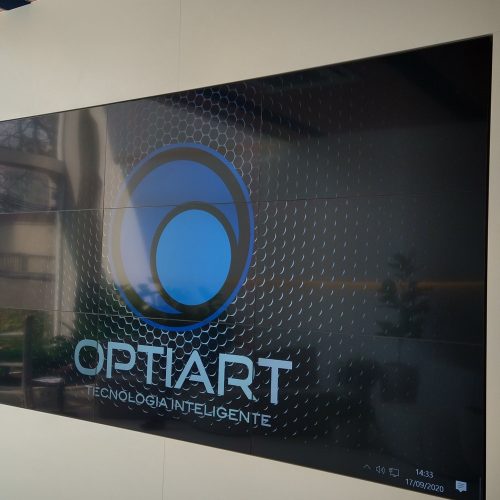 VideoWall 3x3 instalado em nicho na parede do estande de vendas de uma construtora em Campinas, com as nove telas ligadas exibindo conteúdo